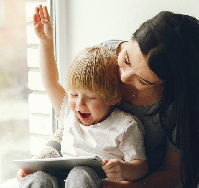 Storytime at Home feature card showing mom and young son reading on tablet