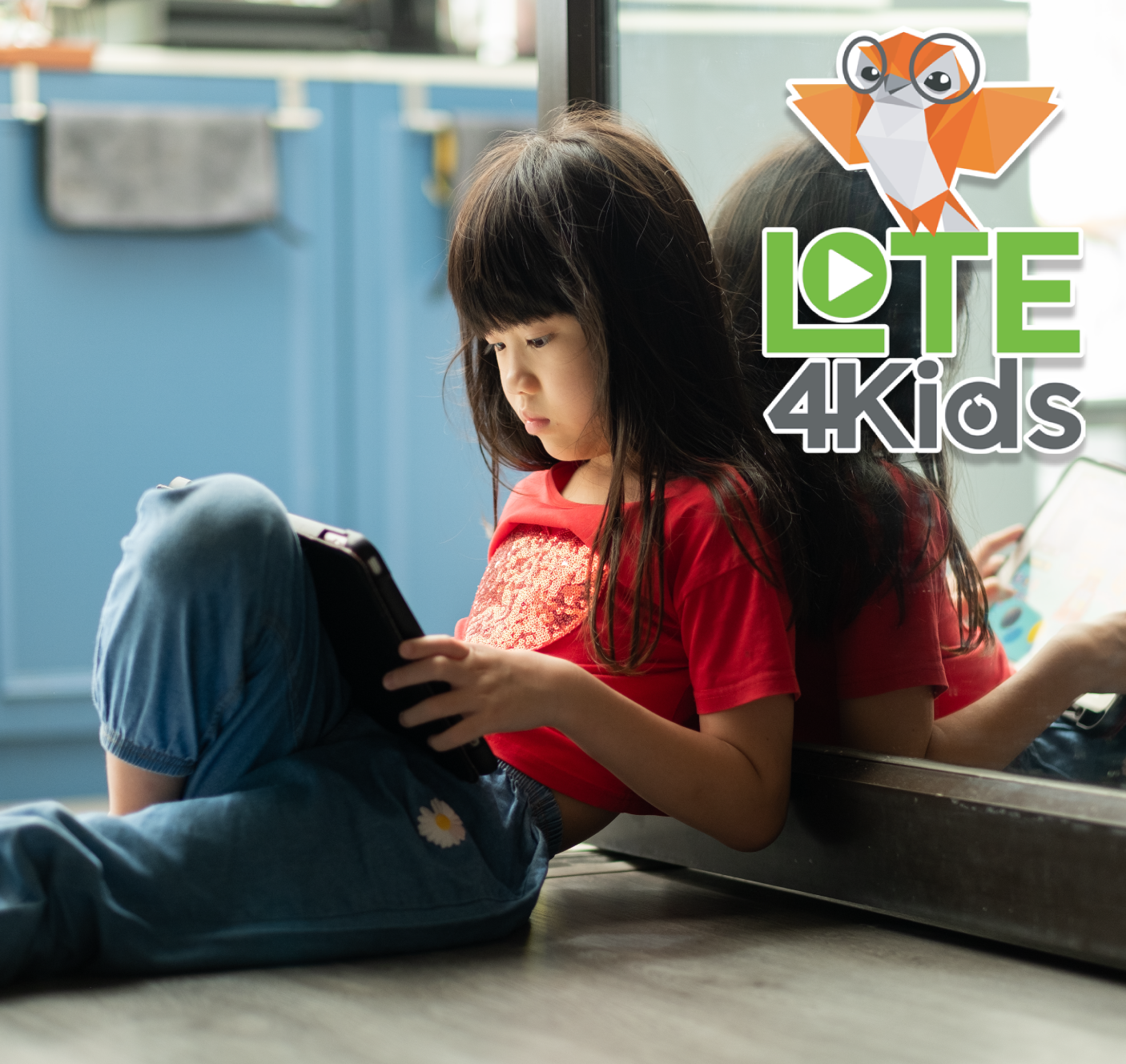 Girl reading on tablet in kitchen