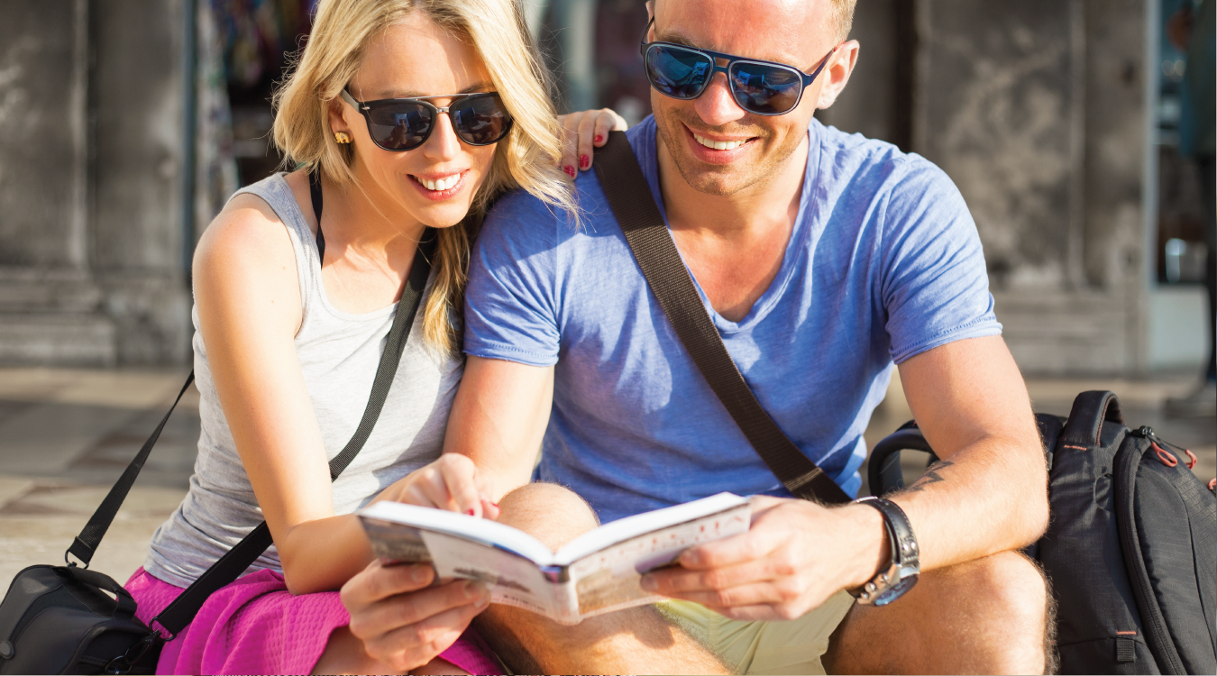 Couple reads guide book in sunlight
