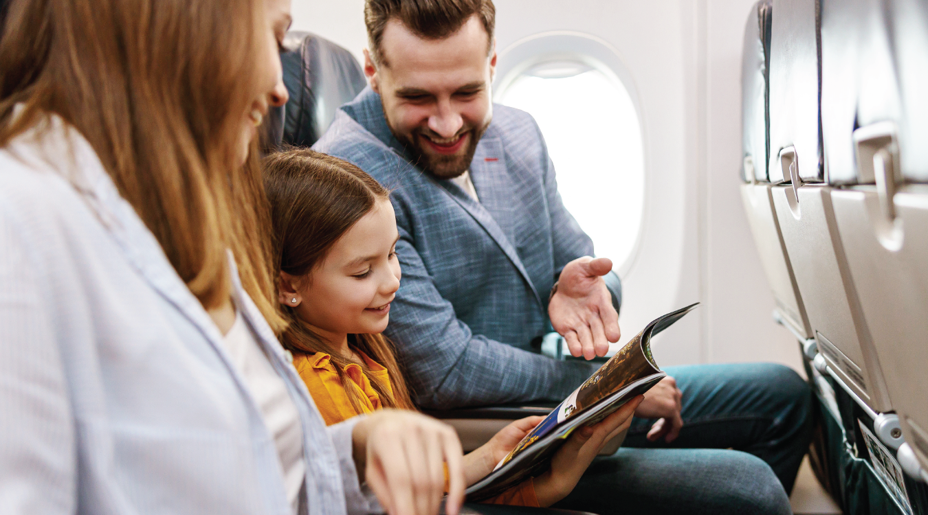 Family reads magazine on plane