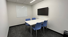 Photo of Study Room B with a table, four chairs, and LCD screen