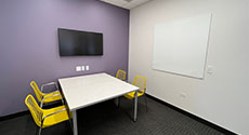 Photo of Youth Study Room D with a Table, Monitor Screen, Four chairs and a dry erase board