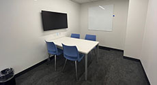 Photo of Study Room A with a table, four chairs, and LCD screen