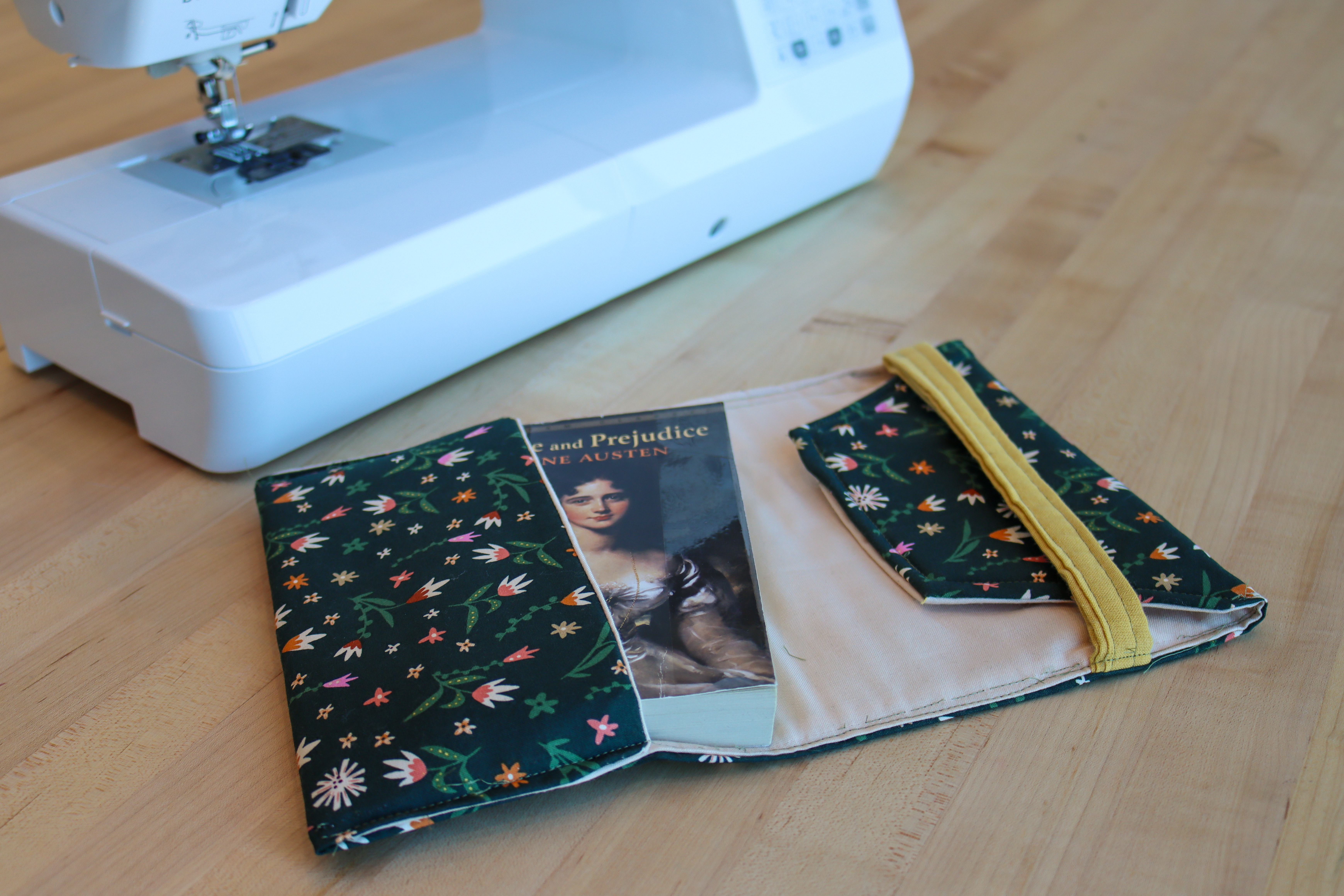 Cloth book cover with a paperback of Pride and Prejudice tucked inside