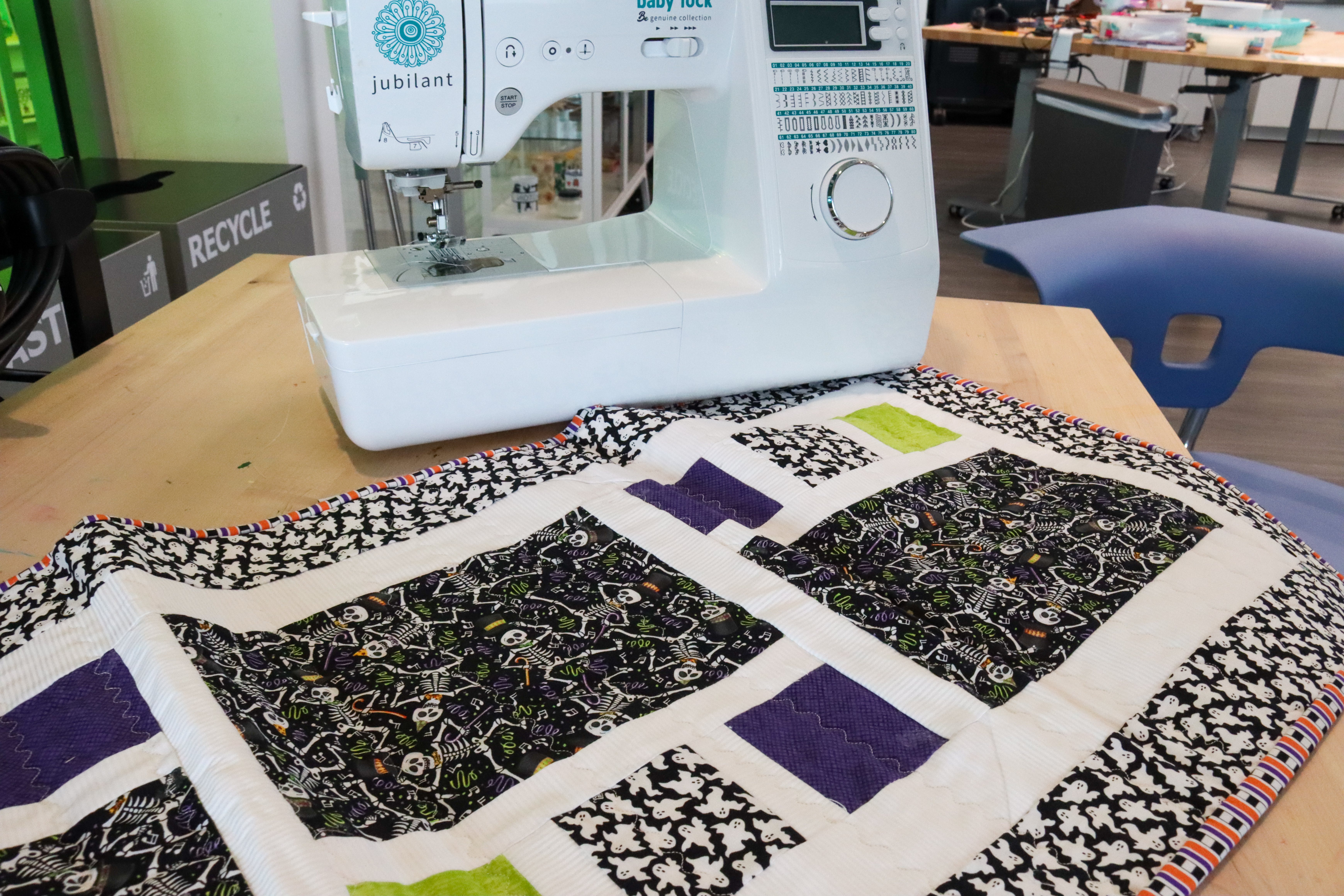 Table runner made from quilted fabric with skeleton and ghost patterns.
