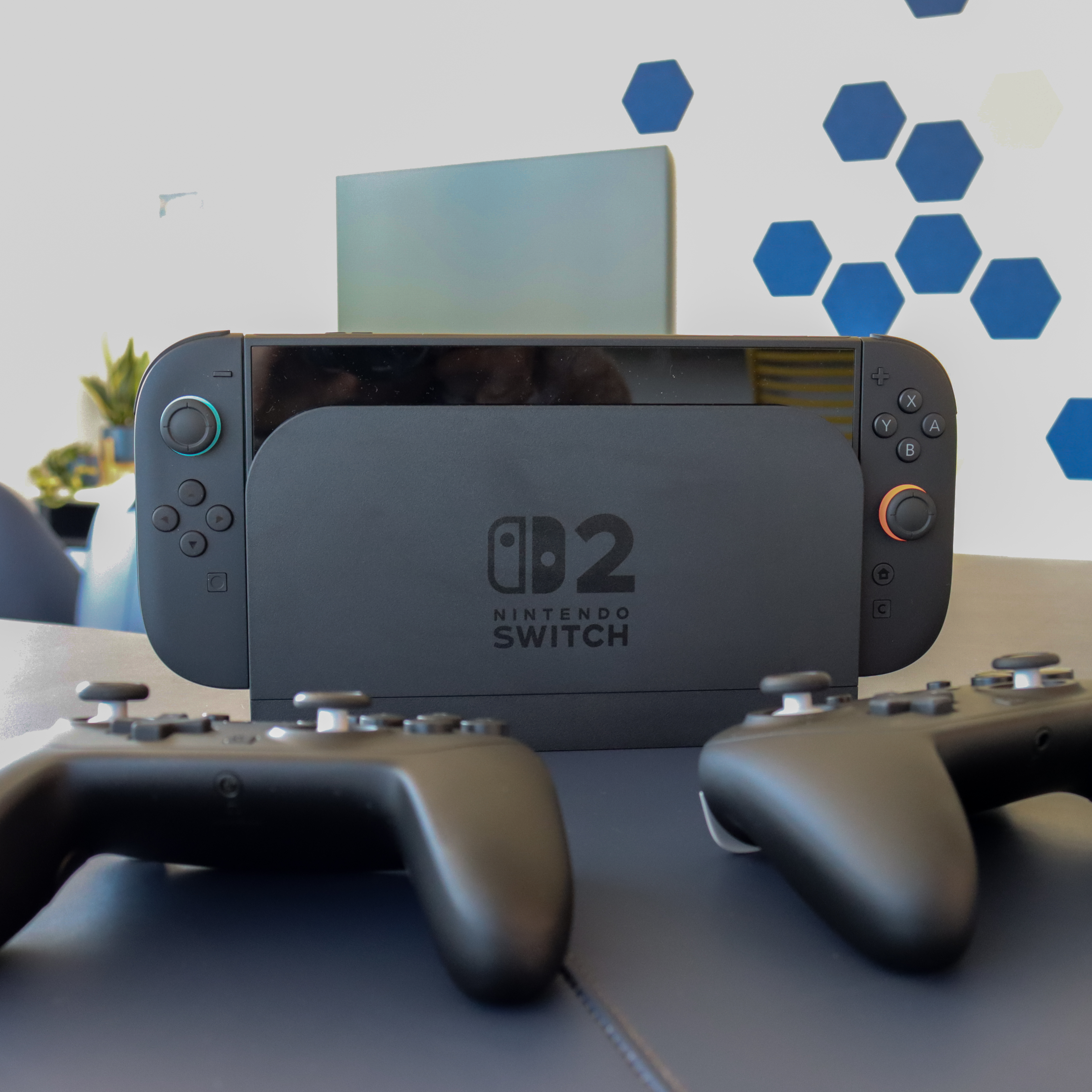 Black Nintendo Switch 2 console and two controllers in the Hive