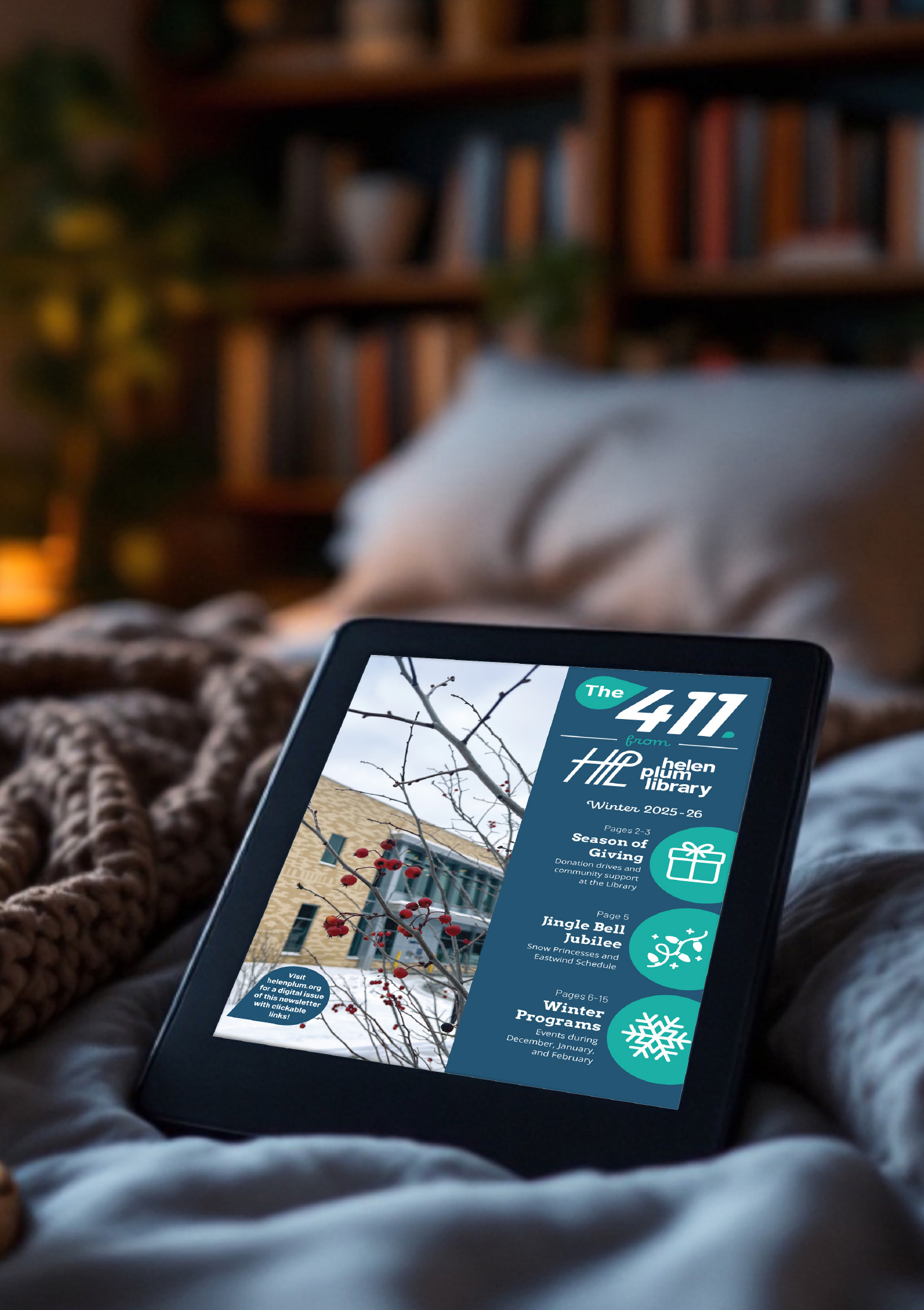 The Winter 411 newsletter displayed on a tablet sitting on a blanket in a cozy bedroom scene