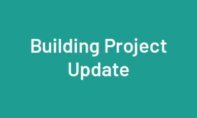 Building Project Update on Teal Background