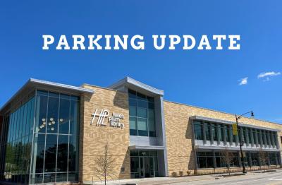 Photo of the new library building with text that reads parking update