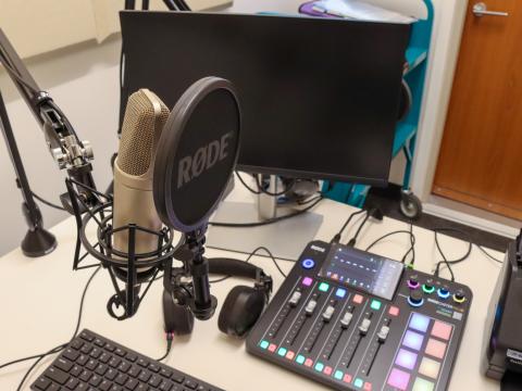 Recording equipment with microphone and mixing board in the Recording Lab