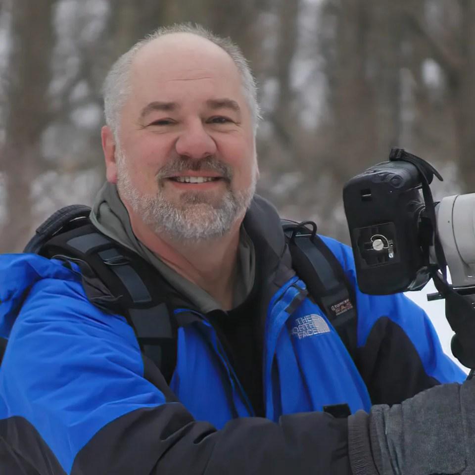 Dan Pollack, nature photographer, photographed outdoors with his camera.
